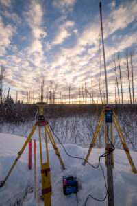 Survey equipment set up in snow at sunset Canada